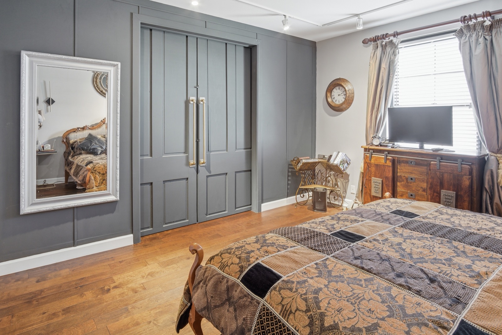 Bedroom with gray paneled closet doors