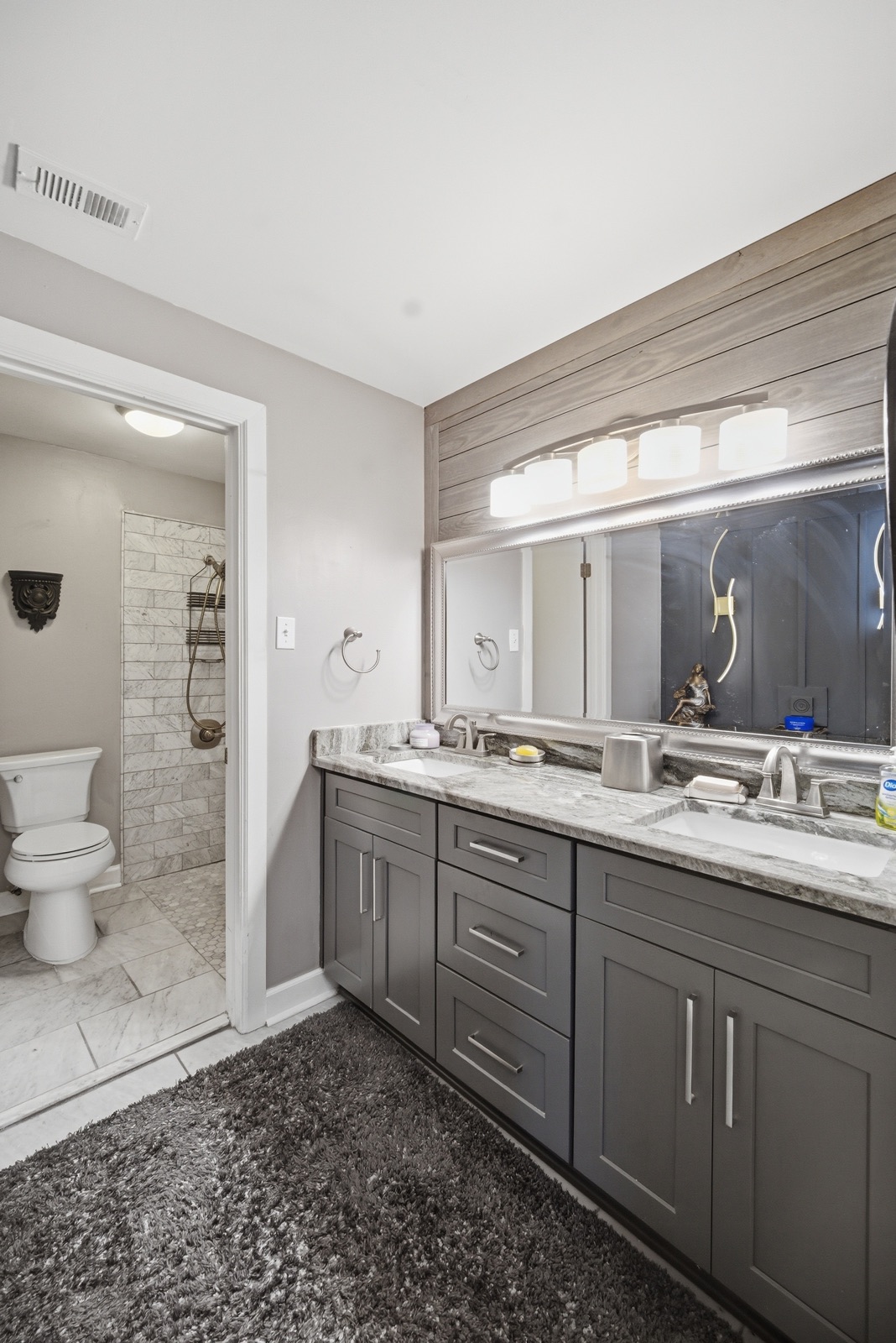 Vanity with walk-in shower beyond